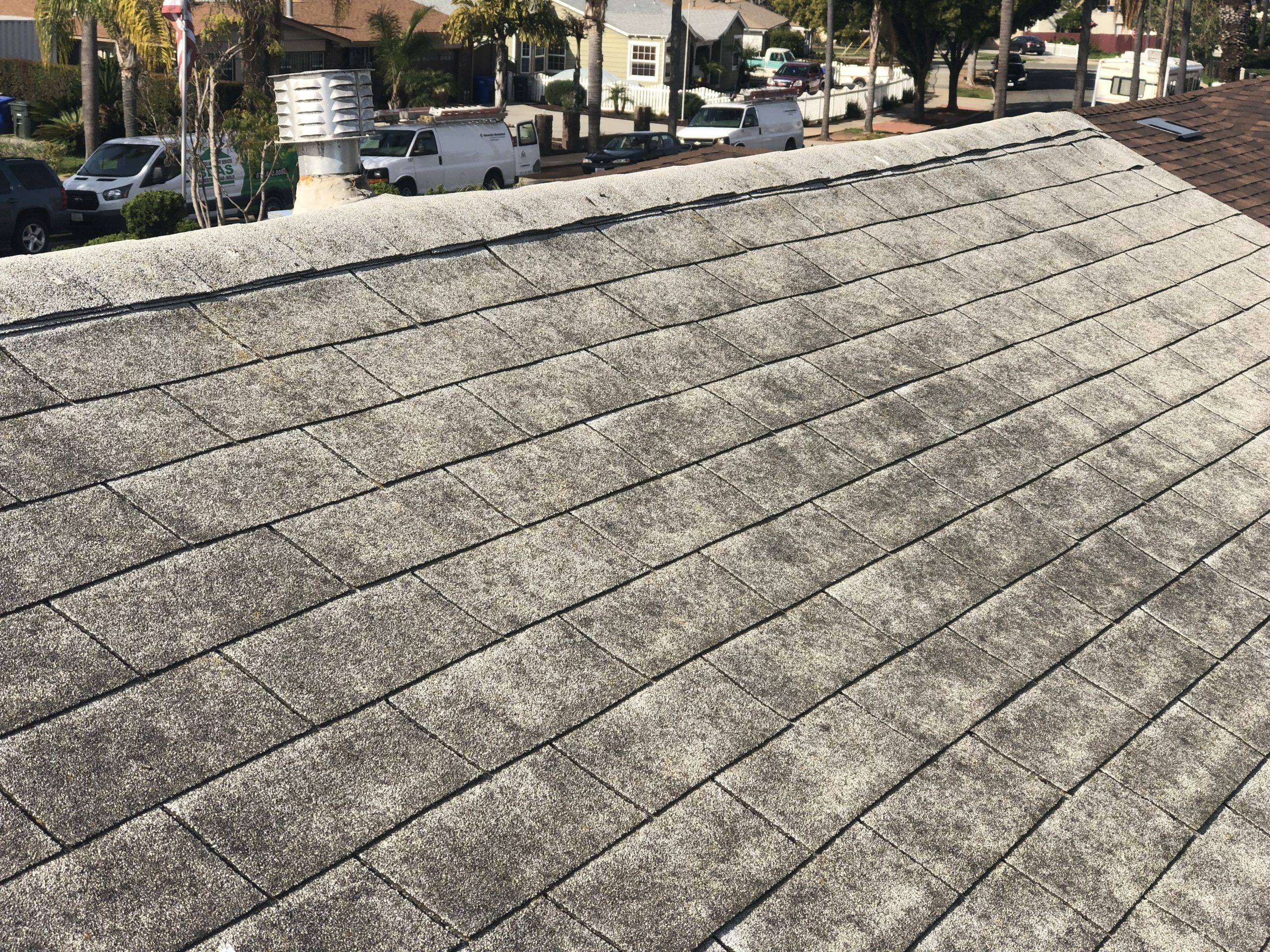 Worn asphalt shingle roof with visible granular loss during a home inspection in Encinitas, California